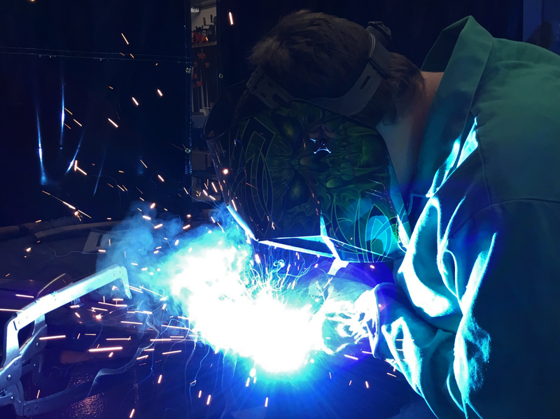 Welding some 3" x 10" miter joints. Hair may or may not have caught fire, so I got it cut.